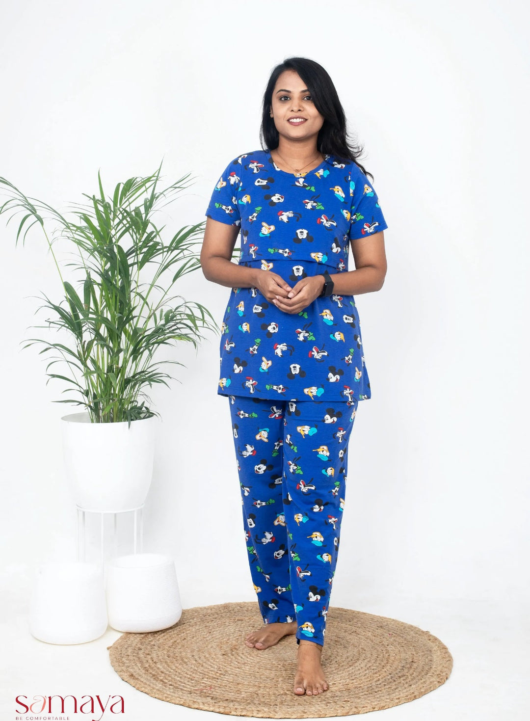 Woman wearing blue Mickey Pant Set lounge wear with cartoon prints, relaxed fit, and soft cotton fabric