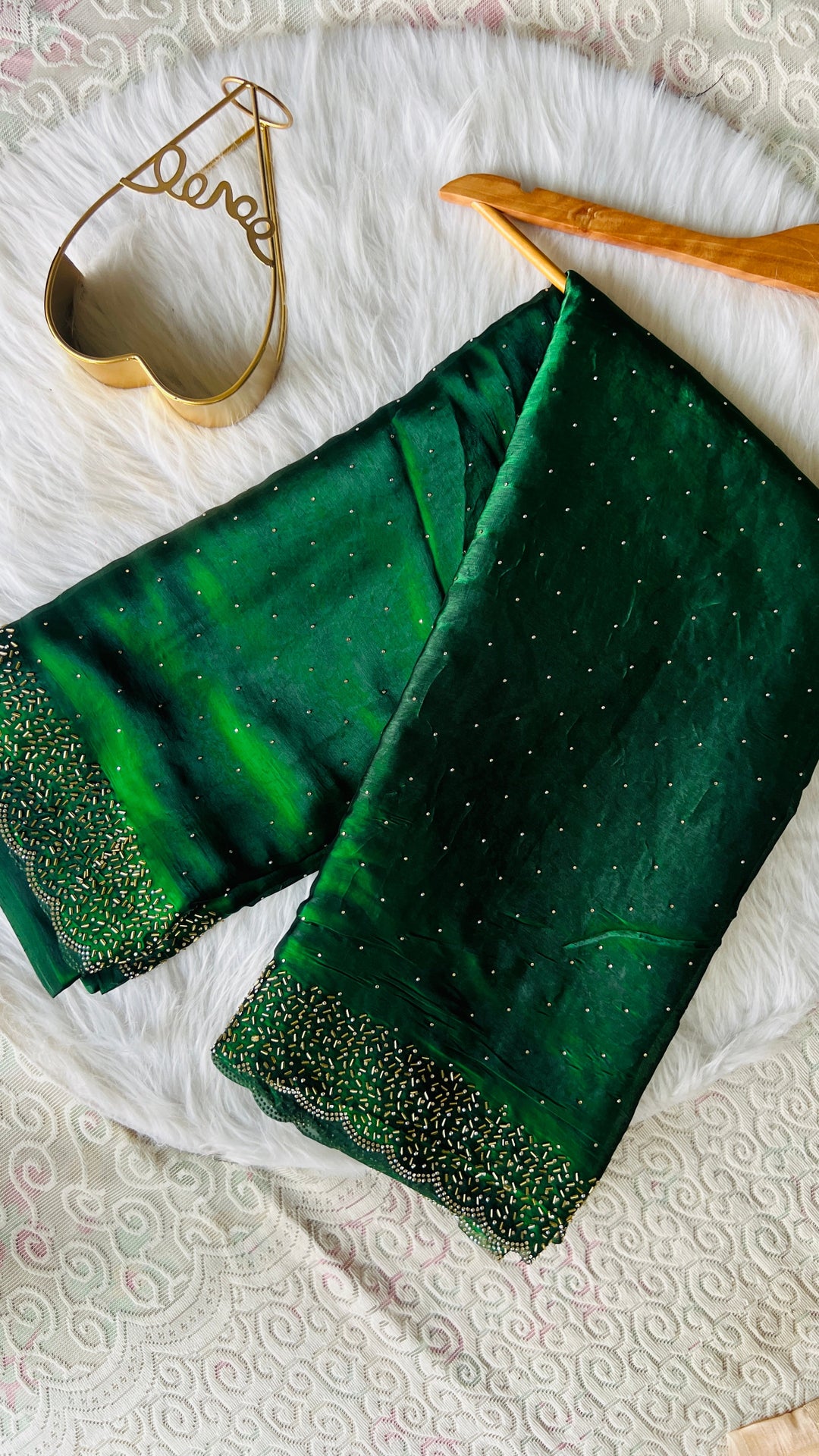 Gorgeous green space silk saree with pearl scalloped border and intricate handwork on white lace background