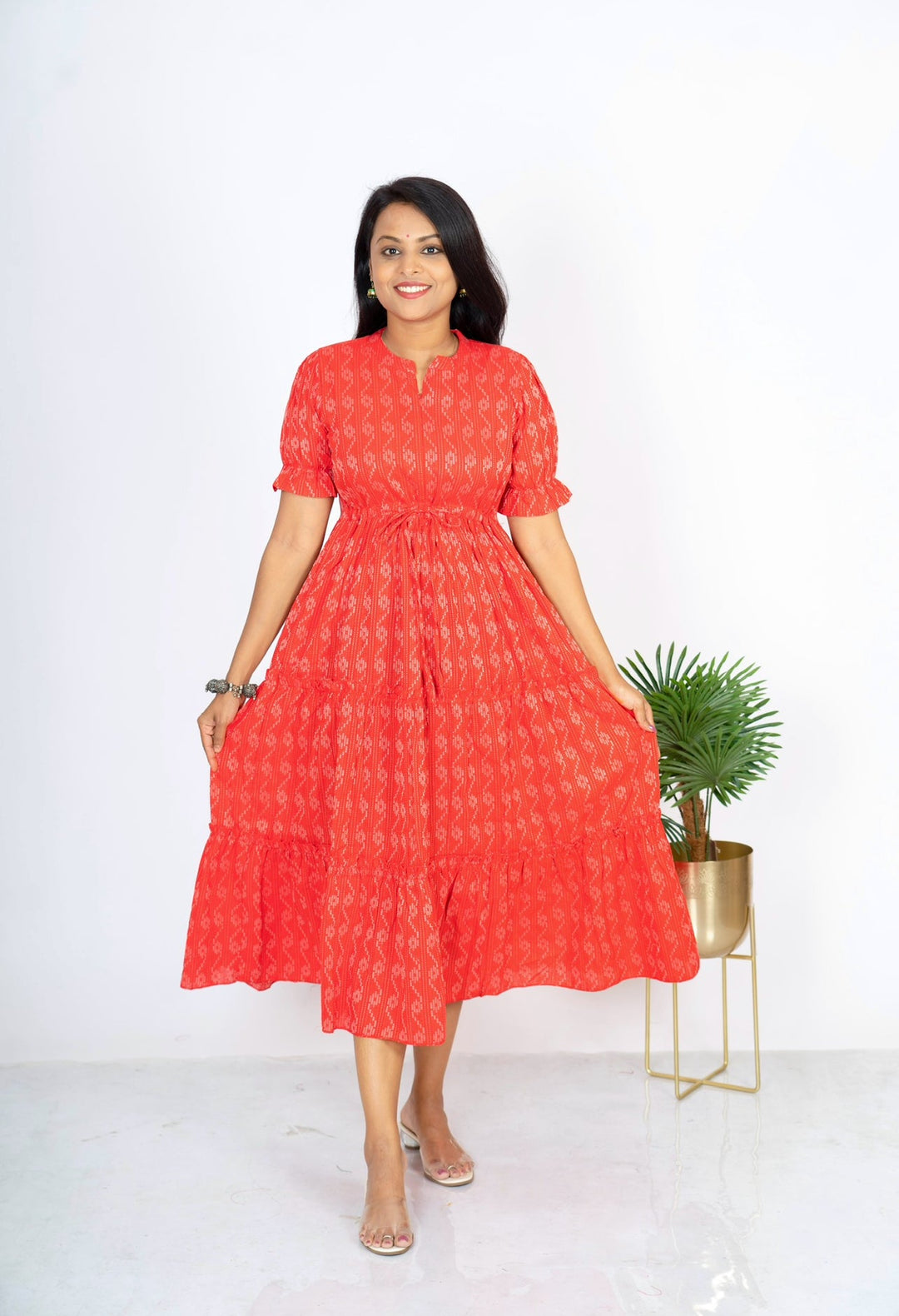 Red cotton day to night dress with floral print, elbow sleeves, collar neck, and center zip for maternity and nursing.