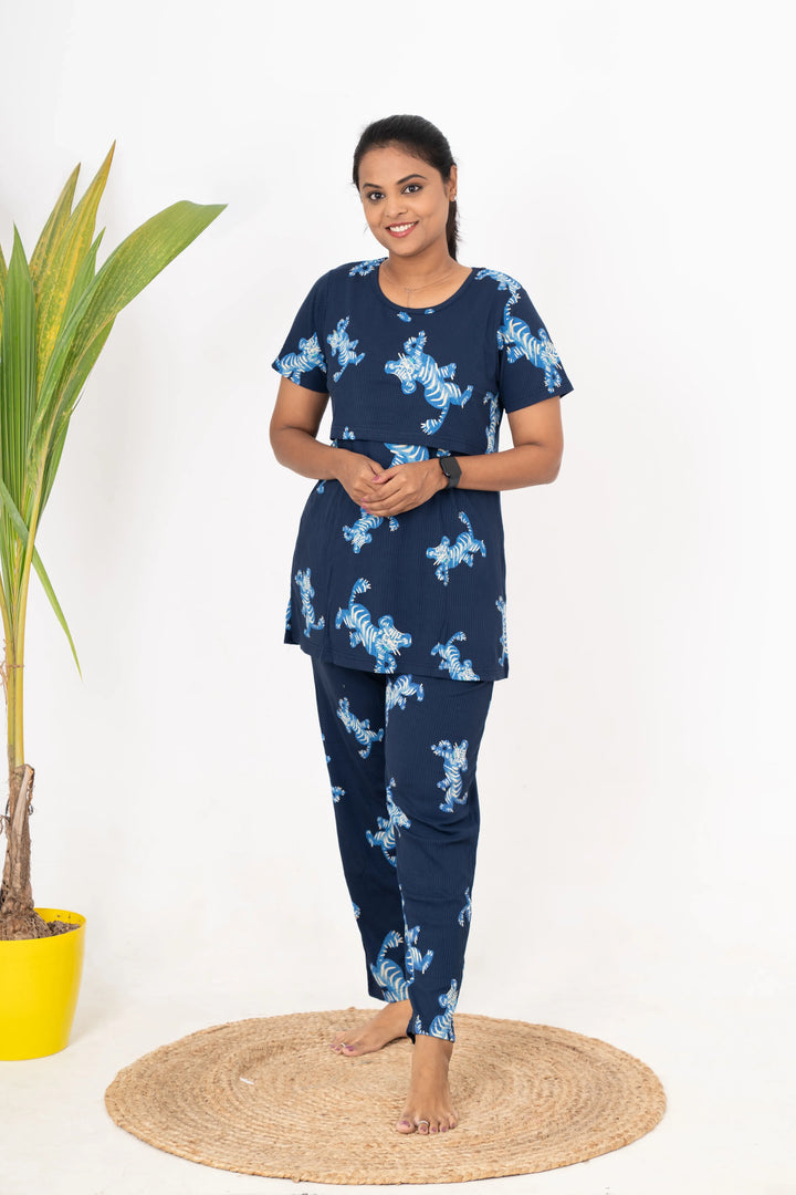 Woman wearing navy blue tiger print ribbed nursing top and pants feeding pant set