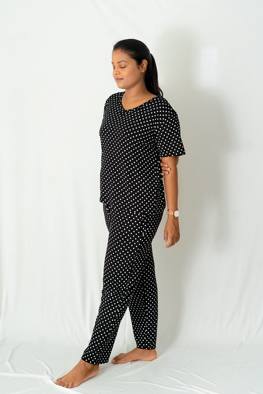 Woman wearing a black and white polka dot retro pant set loungewear with relaxed fit and cotton fabric