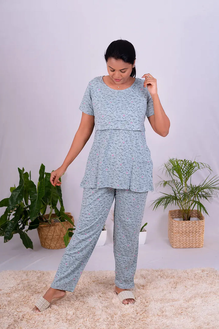 Woman wearing grey cotton cat feeding pant set with nursing flap and broad round neckline