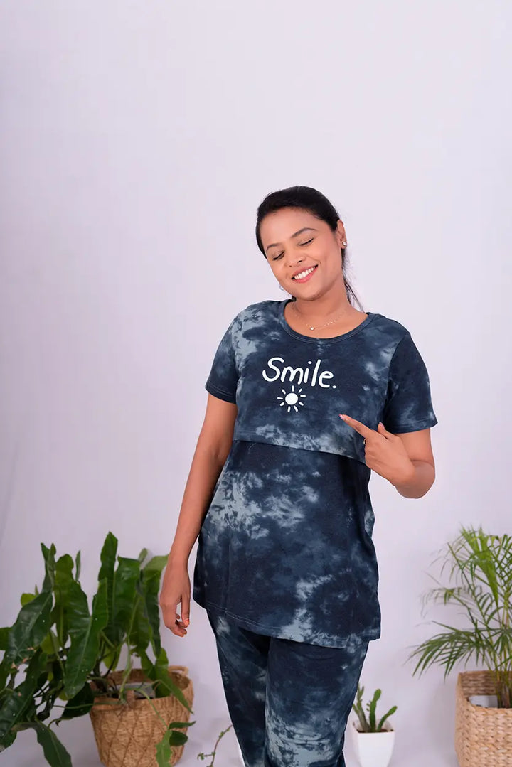 Smiling woman wearing black and grey tie-dye Smile Pant Set nursing friendly lounge wear with pockets and relaxed fit