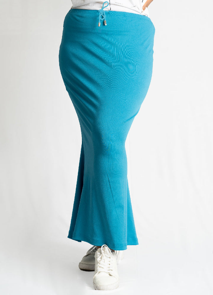 Azure blue Sareeshaper fitted shapewear with flare bottom and drawstring waist, modeled with white sneakers