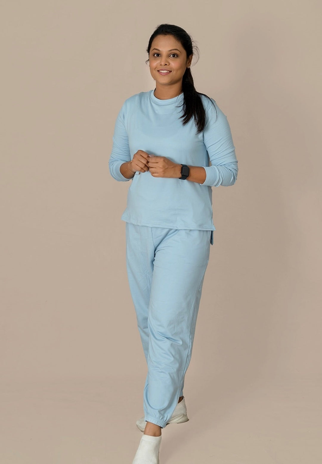 Woman wearing light blue Everyday Cozy Set winter joggers and top made from premium non-feeding soft fabric with relaxed fit and pockets